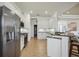 Bright kitchen featuring white cabinets, stainless steel appliances, and granite countertops at 7554 Camden Harbour Dr, Bradenton, FL 34212