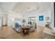 Inviting living room with tile floors, tray ceilings, and views of the lake at 7554 Camden Harbour Dr, Bradenton, FL 34212