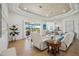 Inviting living room with tile floors, tray ceilings, and views of the lake at 7554 Camden Harbour Dr, Bradenton, FL 34212