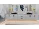 Modern bathroom featuring double sinks, modern lighting, marble counters and decorative art at 800 Blue Shell Loop, Sarasota, FL 34240