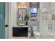 Contemporary bathroom featuring a unique vanity, decorative wall coverings, and sleek glass shower enclosure at 800 Blue Shell Loop, Sarasota, FL 34240