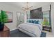 Stylish bedroom featuring modern lighting, luxurious linens and an accent wall at 800 Blue Shell Loop, Sarasota, FL 34240