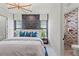 Modern bedroom featuring an accent wall, stylish decor and an ensuite bathroom at 800 Blue Shell Loop, Sarasota, FL 34240