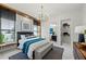 Tastefully decorated bedroom with ensuite bath and luxurious linens, and a neutral color palette at 800 Blue Shell Loop, Sarasota, FL 34240