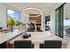 Bright dining area with marble countertops, wine fridge, and water view at 800 Blue Shell Loop, Sarasota, FL 34240