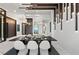 Dining area with unique lighting fixtures, art, and a hall with partial waterfront views at 800 Blue Shell Loop, Sarasota, FL 34240