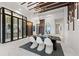 Dining area and wine cellar with unique lighting fixtures and sleek furnishings at 800 Blue Shell Loop, Sarasota, FL 34240