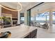 Modern kitchen featuring stainless steel appliances, marble countertops, and an open design with water views at 800 Blue Shell Loop, Sarasota, FL 34240