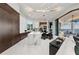 Modern kitchen with marble island, sleek cabinets, and integrated dining area at 800 Blue Shell Loop, Sarasota, FL 34240