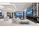 Open living area with fireplace and entertainment center, showcasing the connecting kitchen and waterfront views at 800 Blue Shell Loop, Sarasota, FL 34240