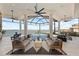 Stunning waterfront living room with soaring ceilings, water views, and elegant contemporary furnishings at 800 Blue Shell Loop, Sarasota, FL 34240