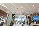 Open-concept living space with decorative lighting, lake views, and seamless access to outdoor living and kitchen area at 800 Blue Shell Loop, Sarasota, FL 34240
