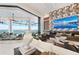 Beautiful living room with a lake view, fireplace, elegant decor, and seamless access to outdoor space at 800 Blue Shell Loop, Sarasota, FL 34240