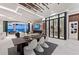 Open-concept living space features dining area, fireplace and entertainment center, and wine cellar at 800 Blue Shell Loop, Sarasota, FL 34240