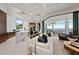 Bright open concept living and kitchen area with disappearing walls and water views at 800 Blue Shell Loop, Sarasota, FL 34240