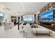 Bright living room with open floor plan, water view, linear fireplace, and a modern accent wall at 800 Blue Shell Loop, Sarasota, FL 34240