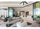 Stylish living room extending to outdoor patio, showcasing the flow to a tranquil waterside setting at 800 Blue Shell Loop, Sarasota, FL 34240