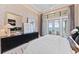 A well-appointed main bedroom featuring water views, stylish decor, and modern furniture at 800 Blue Shell Loop, Sarasota, FL 34240
