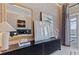 A stylish bedroom features a dark wood dresser with decorative items and water views through French doors at 800 Blue Shell Loop, Sarasota, FL 34240