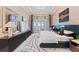 An elegant main bedroom with water views, stylish decor, modern furniture, and an accent wall at 800 Blue Shell Loop, Sarasota, FL 34240