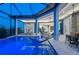 Beautiful pool area features a spa, comfortable seating, and opens to a luxurious home at 800 Blue Shell Loop, Sarasota, FL 34240