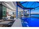 Relaxing waterfront pool and outdoor living area with comfortable lounge chairs at 800 Blue Shell Loop, Sarasota, FL 34240