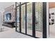 A stunning wine cellar features ample storage with glass doors, providing an elegant display for wine enthusiasts at 800 Blue Shell Loop, Sarasota, FL 34240