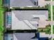 An aerial view shows the roof, landscaping, and screened-in pool of the home at 8335 Sea Glass Ct, Sarasota, FL 34240