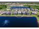 Aerial view of lakeside community, featuring homes with screened pools and lush landscaping at 8335 Sea Glass Ct, Sarasota, FL 34240