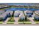 An aerial shot showcases a luxurious home with a lake view and well-maintained landscaping at 8335 Sea Glass Ct, Sarasota, FL 34240