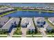 The aerial view shows the house nestled in a beautiful neighborhood with a picturesque lake and stunning fountain views at 8335 Sea Glass Ct, Sarasota, FL 34240