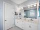 Bathroom with double sinks, white cabinets, and granite countertops at 8335 Sea Glass Ct, Sarasota, FL 34240