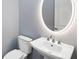 Bathroom featuring modern sink, vanity and illuminated round mirror at 8335 Sea Glass Ct, Sarasota, FL 34240