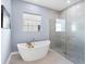Elegant bathroom featuring a freestanding tub and glass-enclosed shower at 8335 Sea Glass Ct, Sarasota, FL 34240