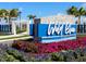 Welcoming entrance sign to Wild Blue at Waterside surrounded by vibrant flowers and lush greenery at 8335 Sea Glass Ct, Sarasota, FL 34240