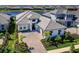 Beautiful single Gathering home with elegant architecture, manicured landscaping, and a brick driveway at 8335 Sea Glass Ct, Sarasota, FL 34240