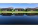The backyard of this home features a scenic view of the pond and a screened-in lanai overlooking the lush lawn at 8335 Sea Glass Ct, Sarasota, FL 34240