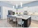 Large kitchen island with seating, white cabinetry, stainless steel appliances, and pendant lighting at 8335 Sea Glass Ct, Sarasota, FL 34240