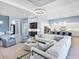 Expansive living room with modern furnishings, open layout, and seamless access to kitchen and dining areas at 8335 Sea Glass Ct, Sarasota, FL 34240