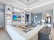 Open-concept living room with built-in shelves, modern decor, and view into the dining area at 8335 Sea Glass Ct, Sarasota, FL 34240