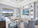 Bright living room with custom built-ins, a large window, a lake view, and modern furniture at 8335 Sea Glass Ct, Sarasota, FL 34240