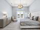 Bright main bedroom featuring tray ceiling, french doors, and a view of the pool at 8335 Sea Glass Ct, Sarasota, FL 34240
