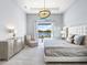 Bedroom suite with lake view, neutral decor, and modern bedside lighting at 8335 Sea Glass Ct, Sarasota, FL 34240