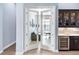 Home office with built-in wine storage and beverage center, viewed through open french doors at 8335 Sea Glass Ct, Sarasota, FL 34240
