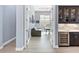 Home office with built-in wine storage and beverage center, viewed through french doors at 8335 Sea Glass Ct, Sarasota, FL 34240