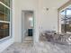 An outdoor patio featuring a dining set and a glimpse into a modern bathroom with a navy vanity and bright lighting at 8335 Sea Glass Ct, Sarasota, FL 34240