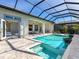 An expansive screened-in pool area with a connected spa, a covered patio, and seamless indoor-outdoor living design at 8335 Sea Glass Ct, Sarasota, FL 34240