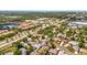 Aerial view showcasing neighborhood's homes, roadways, and lush green landscapes at 8419 Sylvan Woods Dr, Sarasota, FL 34243