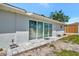 Back patio featuring sliding glass doors and a stone-paved area, ideal for outdoor relaxation at 8419 Sylvan Woods Dr, Sarasota, FL 34243