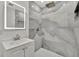 Modern bathroom featuring an LED mirror, gray marble-look tiled shower, and updated sink vanity at 8419 Sylvan Woods Dr, Sarasota, FL 34243